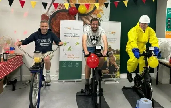 2023 Ronald McDonald House fundraiser - three people riding indoor bikes